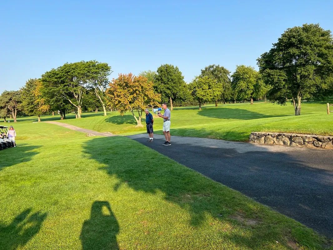 A Man Talking in Mike on the Green Ground